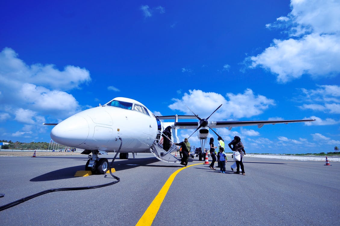 Passengers boarding airplane on runway - Flexibility Is The Traveler's Best Friend
