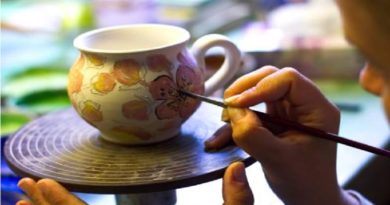 DIY Gifts Artist painting an abstract floral design onto a cup.