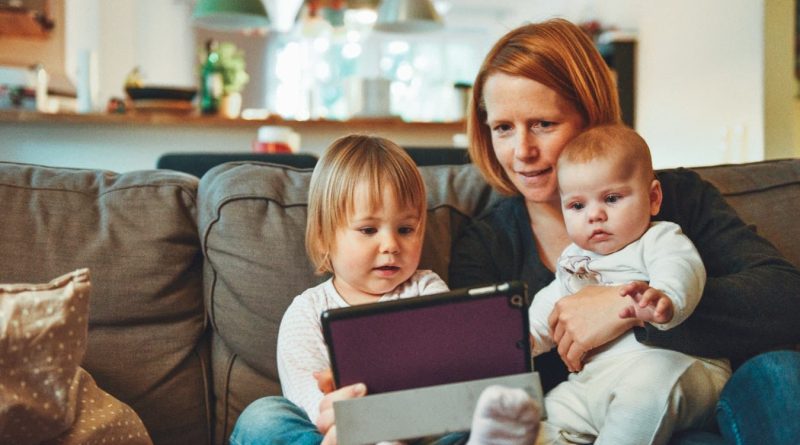 Mom with Kids watching tablet - How to Handle the Madness of Raising Kids While Starting a Business