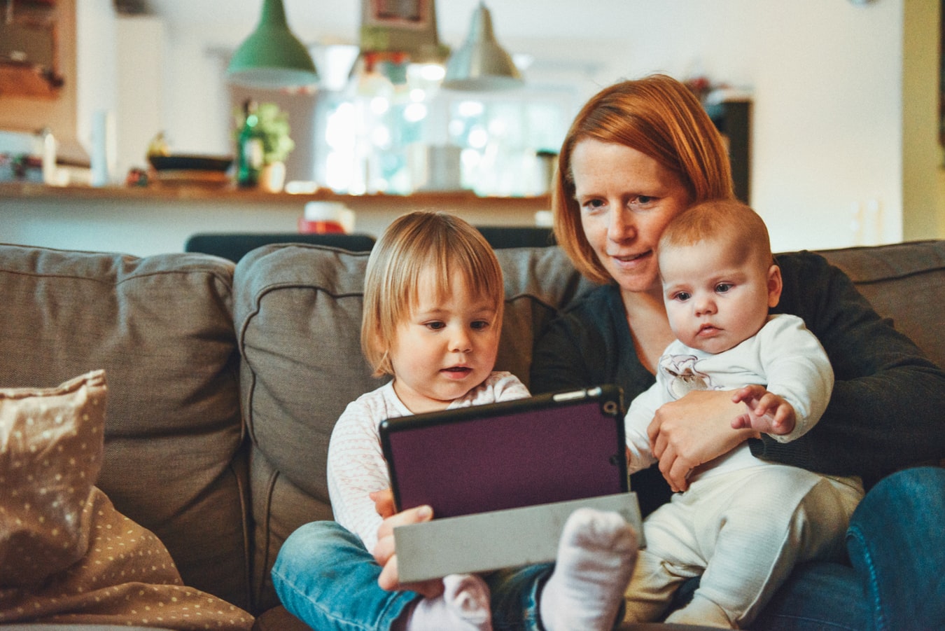 Mom with Kids watching tablet - How to Handle the Madness of Raising Kids While Starting a Business