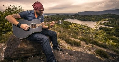 Guy playing a guitar in nature at sunset -3 Tips for Making Your Hobbies and Pastimes More Meaningful