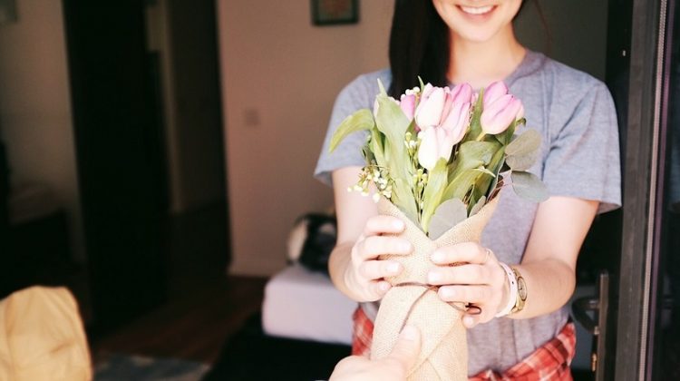 Woman receiving a bouquet of flowers - Best Gifts for A Business Lady