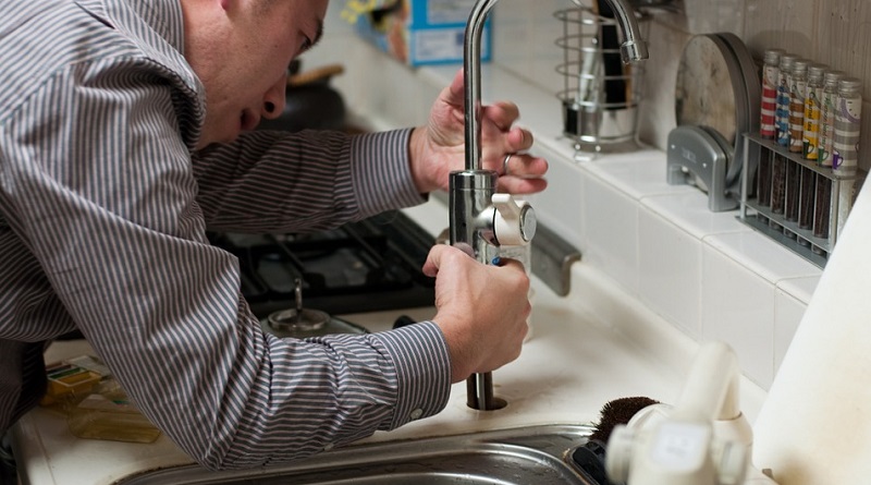 Plumber Repairing Kitchen Faucet - The Most Common Emergency Plumbing Issues