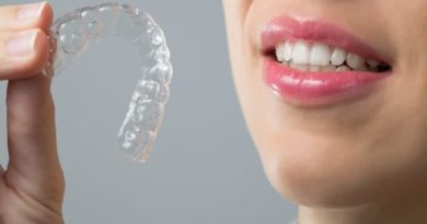 Woman Holding Clear Aligners