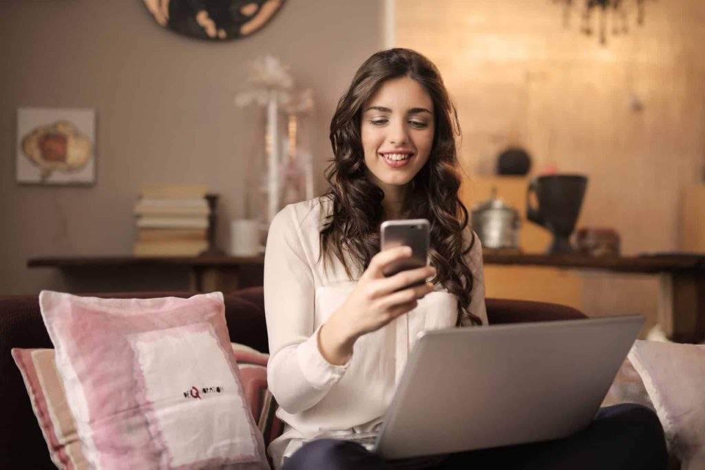 Woman with Laptop and Cell Phone -