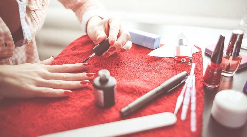 Woman doing her nails - Boost Your Beauty Routine Without Visiting the Salon with These At-Home Treatments