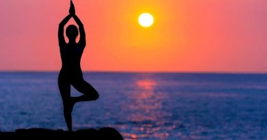 Woman Doing Yoga on Beach -