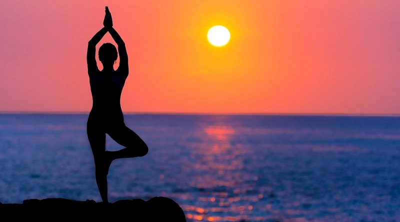 Woman Doing Yoga on Beach -