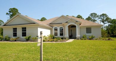 Beige and White Home with For Sale Sign - Fixing Curb Appeal Problems