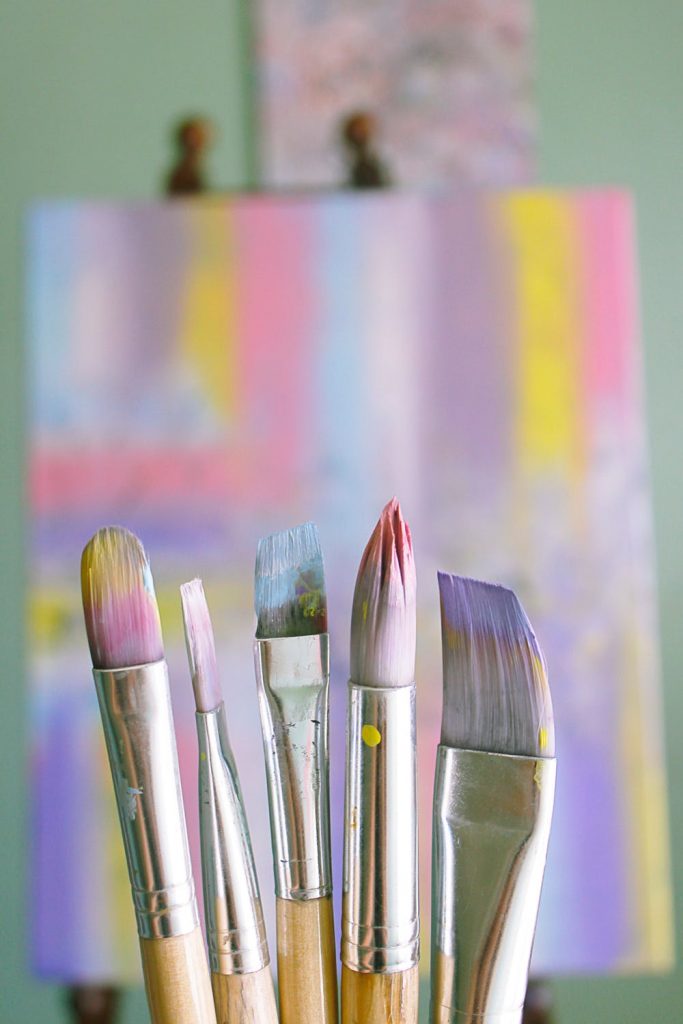 Paint brushes in front of a pastel canvas - Transform Your Garage