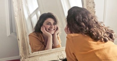 Smiling Brunett Woman Looking into Lovely Old Framed Mirror - Ways to Remove Facial Hair