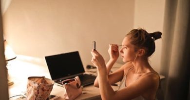 Woman applying makeup at desk -10 Best Foundations