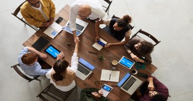 Office Staff Around Table with Laptops - Make Your Organization More Innovative