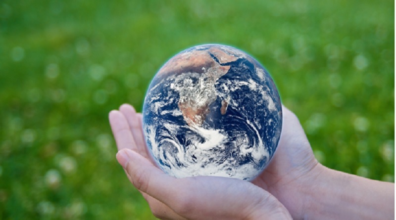 Globe in outstretched hands.- Climate Change