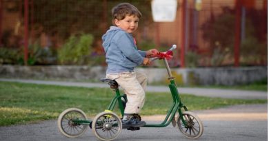 Little boy on green tricycle - Toys For 3-Year-Old Boys