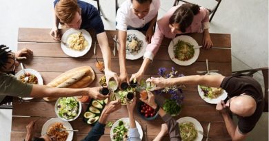 People toasting at table filled with food - Great Destinations for Foodies