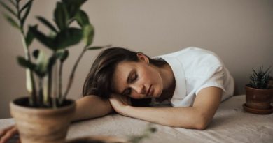 Woman sleeping with head on table - Sleep Disorders