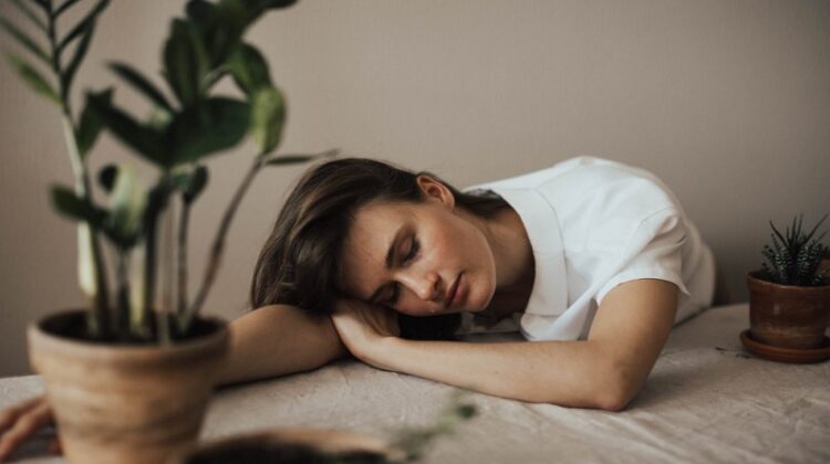 Woman sleeping with head on table - Sleep Disorders