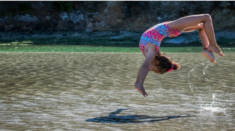Little Girl doing flips in the water -