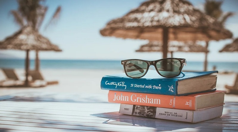 Books and Sunglasses on a table at the beach -