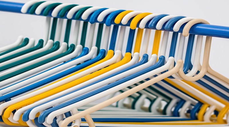 Colorful Plastic Clothes Hangers on Closet Rod - Decluttering and Organizing Your Home