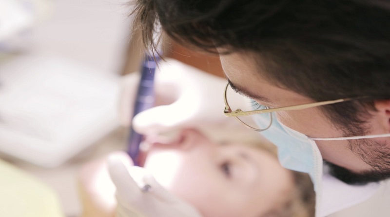 Dentist in Mask working on Patient - What Is Smile Makeover