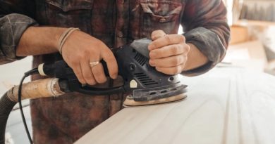 Man sanding wood with orbital sander - Benefits of having an orbital sander