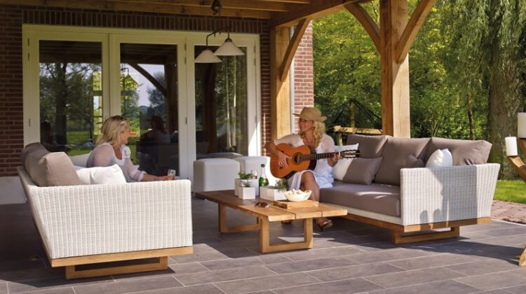 Two women in white dressed on patio - Care Tips to Make Your Patio Shine