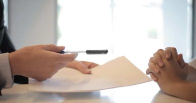 Hands across desk with papers and pen - Home Improvement Loans