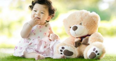 Baby Girl in Floral Dress sitting on Grass with Teddy Bear - baby girl clothes