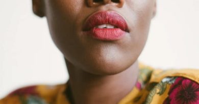 Up Close Photo of Beautiful Black Woman in Yellow Dress with Flowers