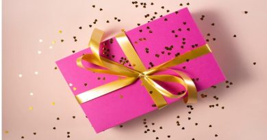 Box Wrapped in Bright Pink Paper and Tied with a Gold Ribbon