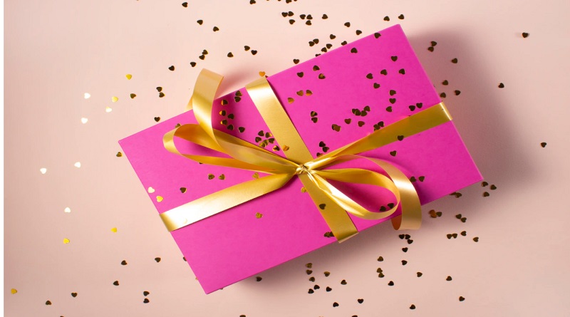 Box Wrapped in Bright Pink Paper and Tied with a Gold Ribbon