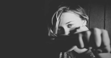 Fundamental Rules for Self-Defense Black and White Photo of a Woman Punching Out Her Fist