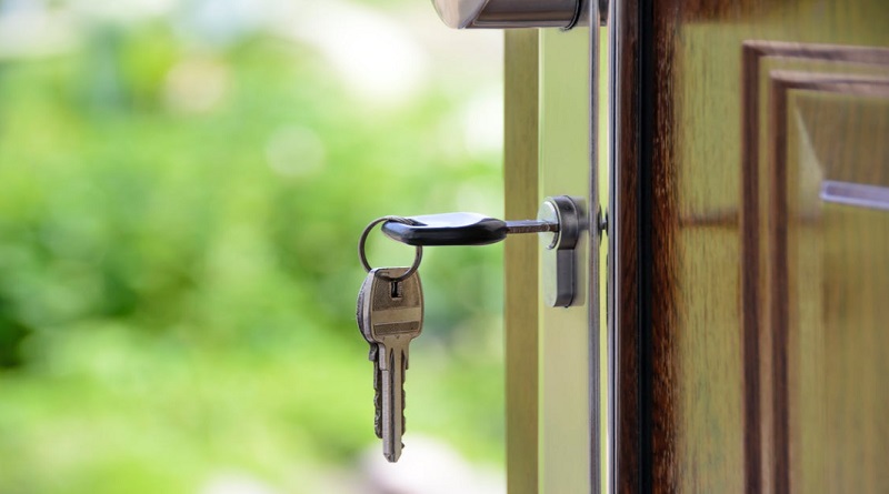 Owning a Home Keys in front door of home