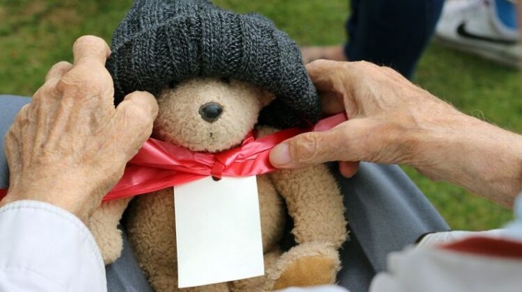 Retirement Gift Ideas Teddy Bear on Older Person's Lap
