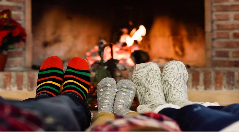 Create a More Comfortable Environment Family in Socks sitting in front of a fire