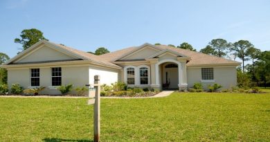 Right Time To Sell Your Home White and Beige Concrete Home with For Sale Sign in Yard