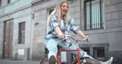 Different Types of Bikes Woman in Plaid Shirt and Jeans, on Red Bike