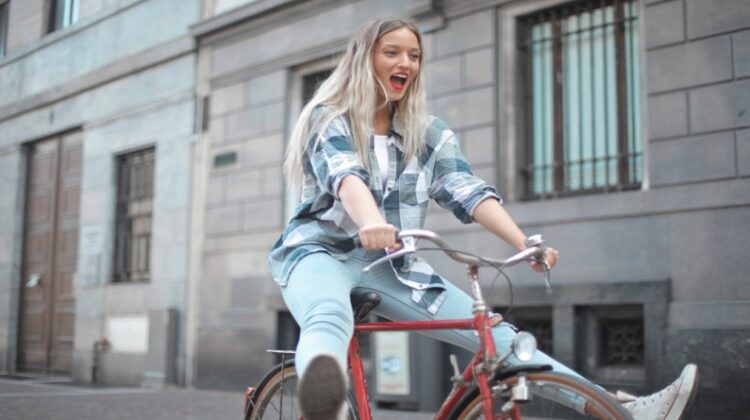 Different Types of Bikes Woman in Plaid Shirt and Jeans, on Red Bike