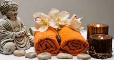 A Little Pampering Rolled up towels, lighted candles, flowers, and a Buddha