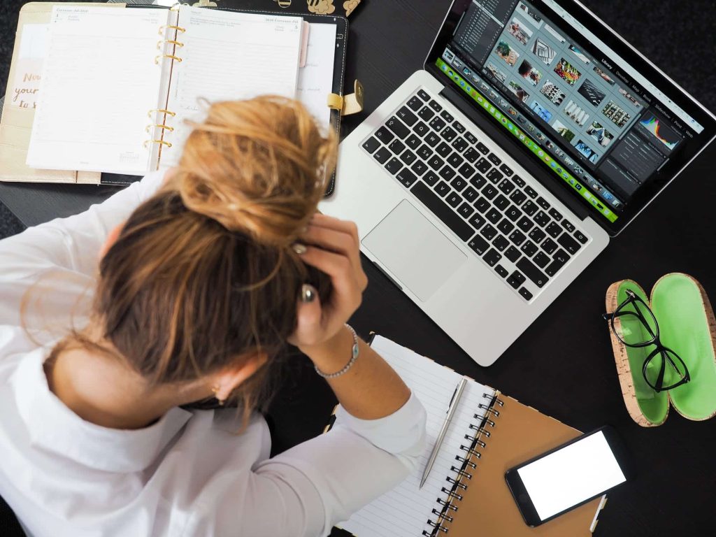 Some Of Lifes Problems Woman at computer with elbows on desk and hands on head