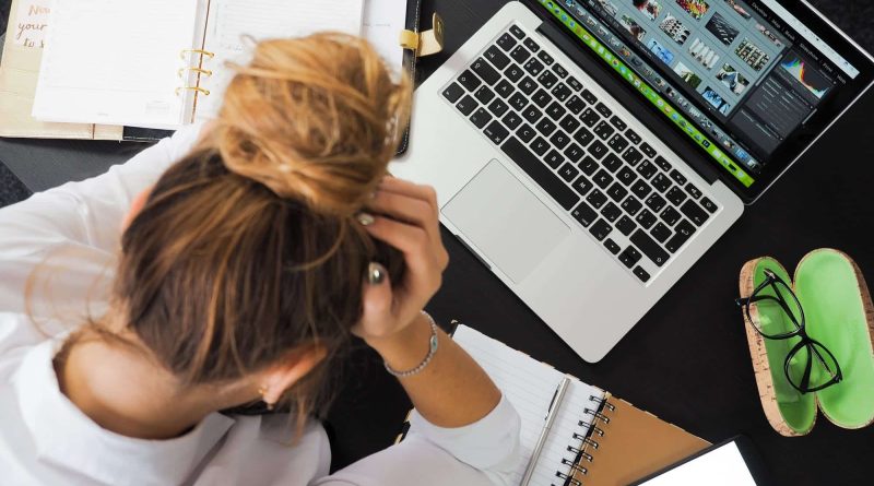 Some Of Lifes Problems Woman at computer with elbows on desk and hands on head
