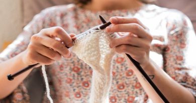 How To Help Keep Down Your Stress Levels Woman in floral top knitting with white yarn
