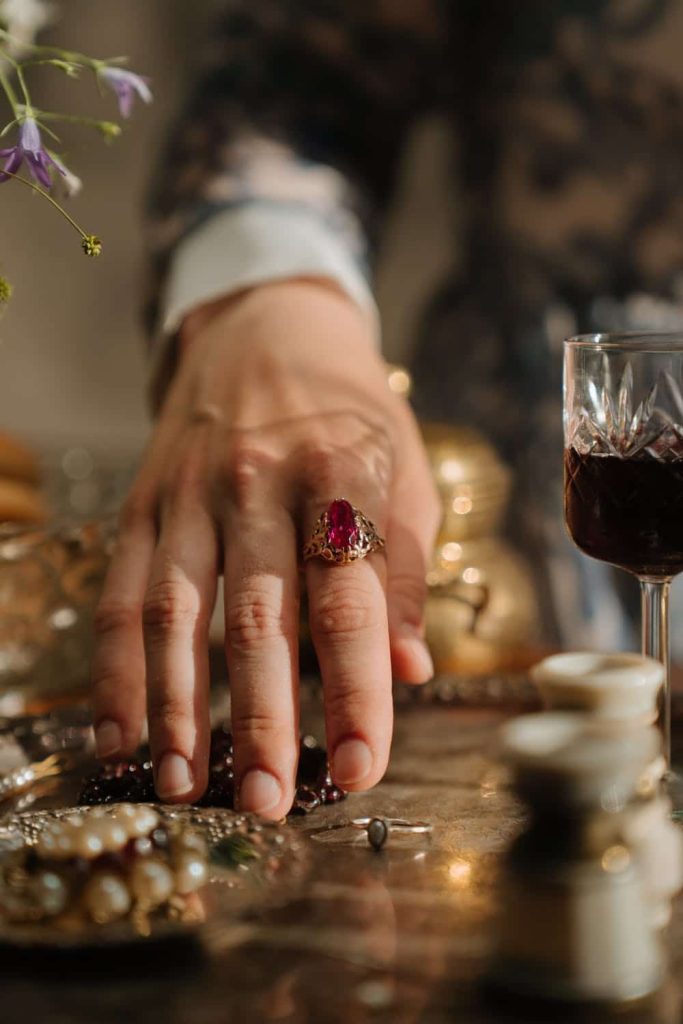 Jewellry Etiquette Hand with ring with red gem in gold setting