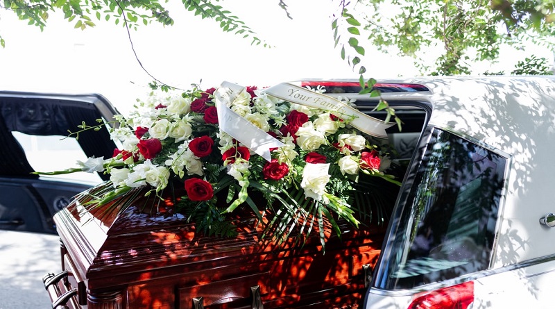 To-Do's to Say The Last Goodbye to your Beloved with Love and Care White Hearse with Casket adorned with Red and White Roses
