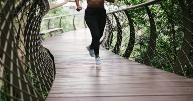 Latest Fitness Trends Woman Running on wooden trail