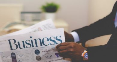 Take Your Business to the Next Level Businessman holding a copy of Business Section of Newspaper