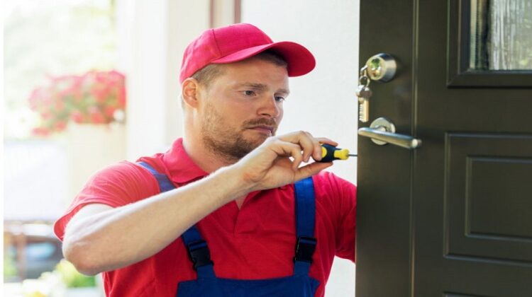 5 Tools Every Locksmith Should Have Locksmith working on a door