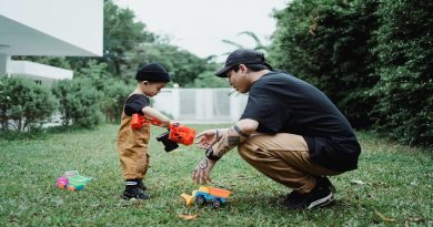 Get Your Garden Ready Man and Little Boy in Back Yard playing with toy trucks